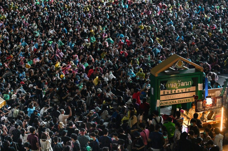 A street vendor sells food as protesters take part in an anti-government rally at Asok in Bangkok