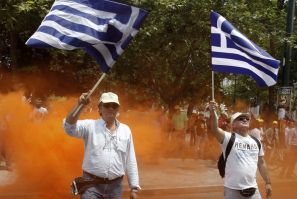 Employees of OTE Telecom wave Greek national flags during a rally against the government&#039;s privatisation plans in Athens