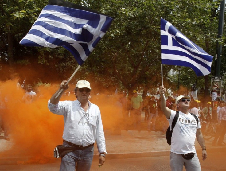 Employees of OTE Telecom wave Greek national flags during a rally against the government&#039;s privatisation plans in Athens