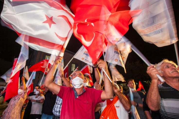 Supporters of right-wing Turkish nationalist Ersin Tatar celebrate his win in the presidential election in the northern part of Nicosia on Sunday night