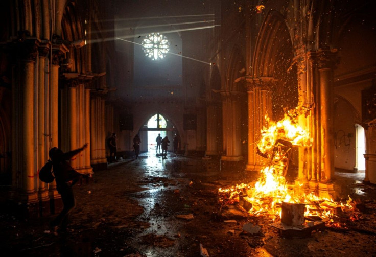 Demonstrators start a fire inside the San Francisco de Borja church in Santiago, Chile