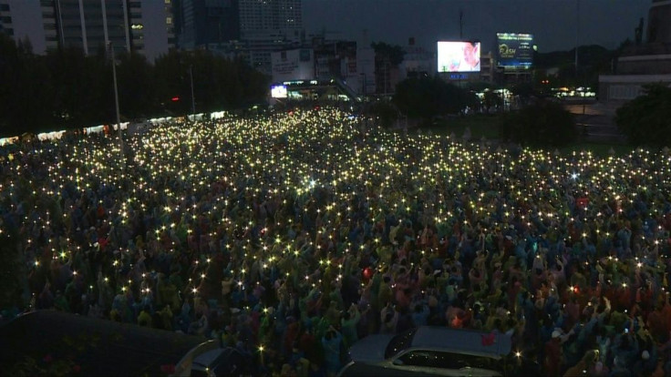 Tens of thousands of pro-democracy protestors take over a major Bangkok intersection with posters bearing the faces of arrested activists, defying a ban on gatherings and stern warnings from authorities who have escalated a crackdown in recent days.