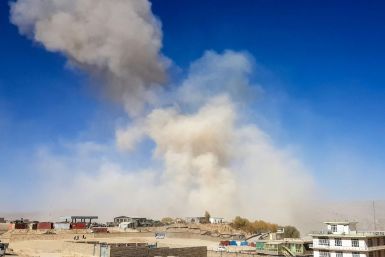 Smoke rises from the site of a car bomb attack that targeted an Afghan police headquarters in Feroz Koh