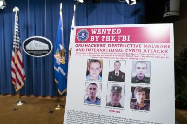 An FBI poster shows six Russian military intelligence officers accused of staging cyberattacks