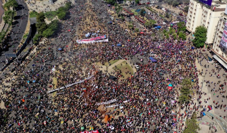 Aerial view of a demonstration with a banner reading âWe will overcomeâ as marchers mark the first anniversary of Chile's social protests on October 18 2020