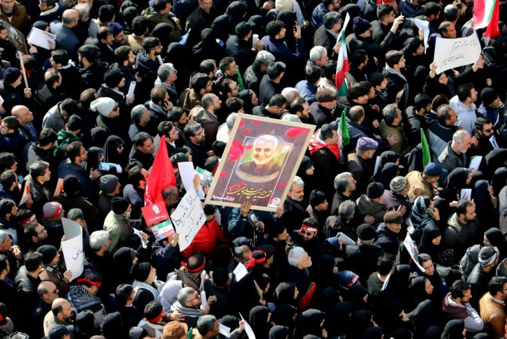 Iranian mourners carry a picture of military commander Qasem Soleimani, killed in a US drone strike in Baghdad, during a funeral procession in Tehran in January, 2020