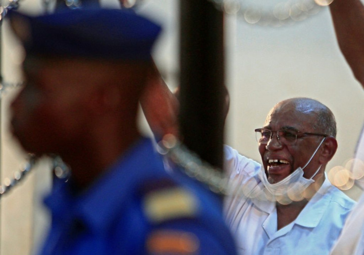 Sudan's ousted president Omar al-Bashir gestures during his trial in the capital Khartoum on October 20, 2020