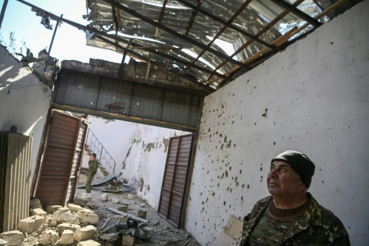The mayor of Martakert Misha Gyurjian stands inside a building destroyed by shelling