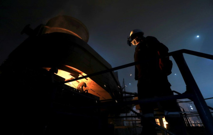 An Iraqi worker operates a furnace for steelmaking at Hend steel company in Arbil