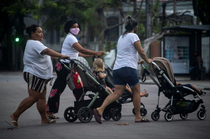 Babysitters push children in strollers in Rio de Janeiro in August 2020, amid the coronavirus pandemic