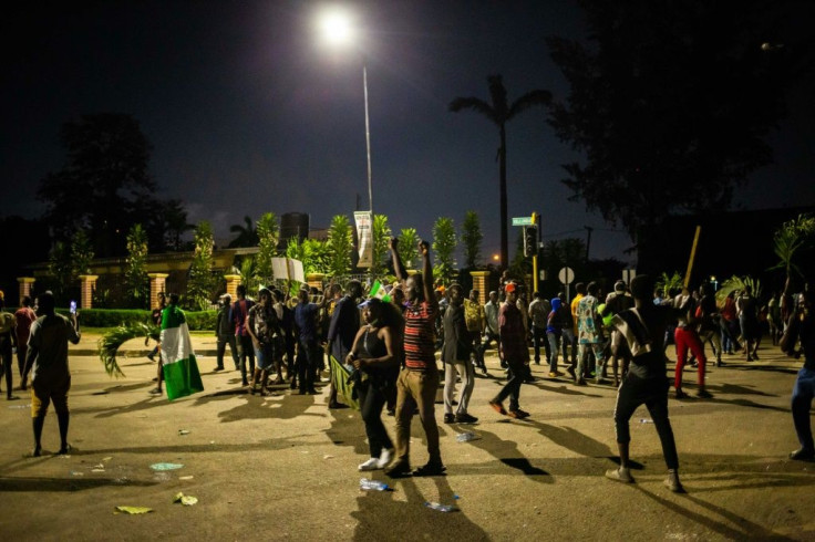 Witnesses said armed gunmen opened fire on a crowd of over 1,000 people to disperse them after a curfew was imposed to end spiralling protests over police brutalityÂ 