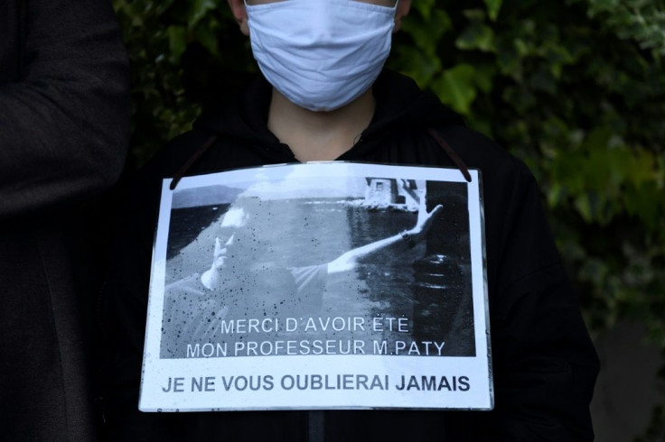 One marcher displayed a sign reading: 'Thank you for having been my teacher Mr Paty. I will never forget you'