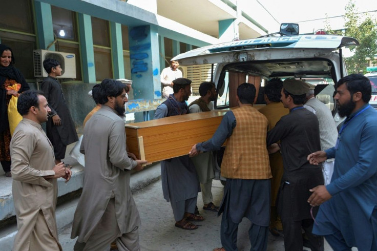 Relatives carry the coffin of a victim, who was killed in a stampede, outside a mortuary in Jalalabad on October 21, 2020