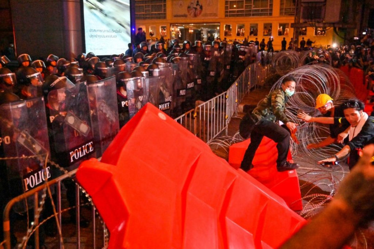 Pro-democracy protesters pushed barricades past barbed wire as riot police stood guard