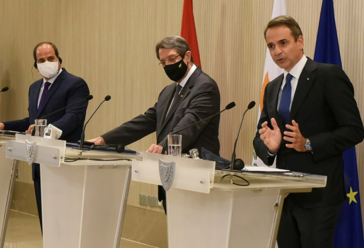 Cypriot President Nicos Anastasiades (C) and Egyptian President Abdel Fattah al-Sisi (L) watch on as Greek Prime Minister Kyriakos Mitsotakis speaks at a joint news conference in Nicosia on October 21, 2020