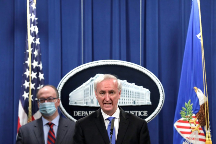 Deputy US Attorney General Jeffrey Rosen(C) announces that Purdue Pharma has agreed to plead guilty to criminal charges over its sales of the addictive prescription opioid OxyContin, which fed a national addiction epidemic