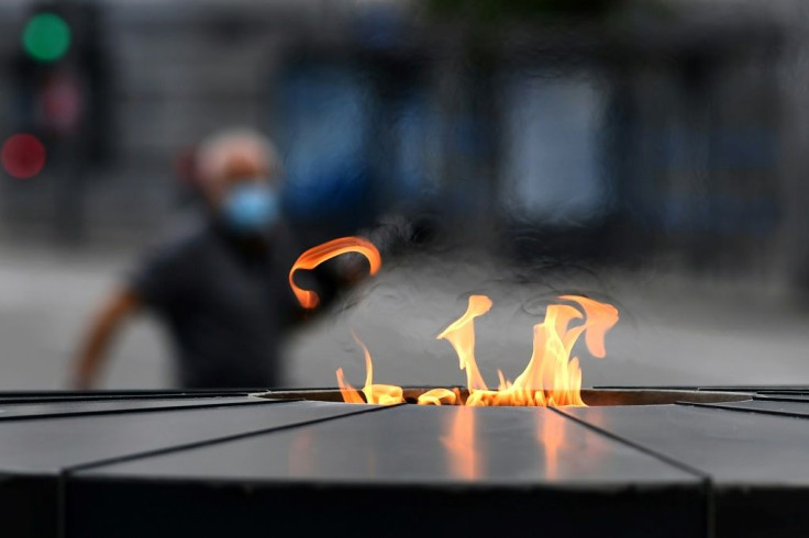 A man (picured May 2020) walks past a memorial paying tribute to the victims of Covid-19 in Madrid, Spain