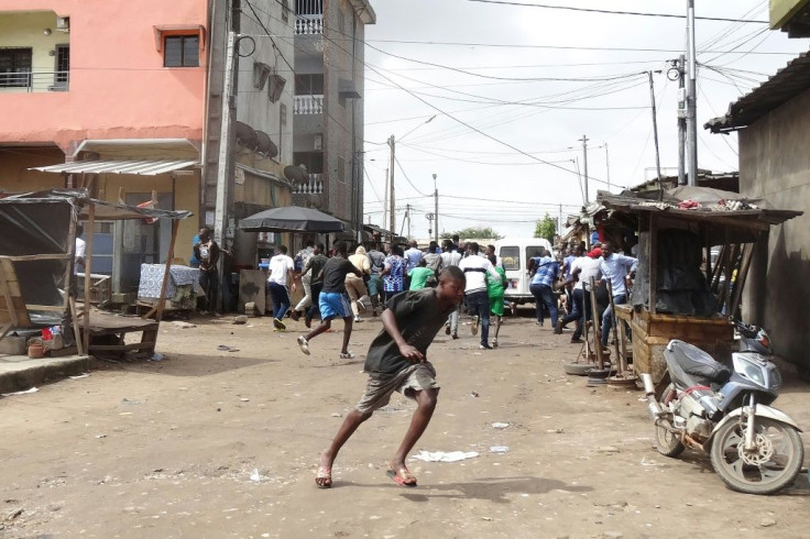 People flee while demonstrators are dispersed in the Cocody district of Abidjan on October 19, 2020, during a demonstration against the third mandate of outgoing Ivorian President Alassane Ouattara