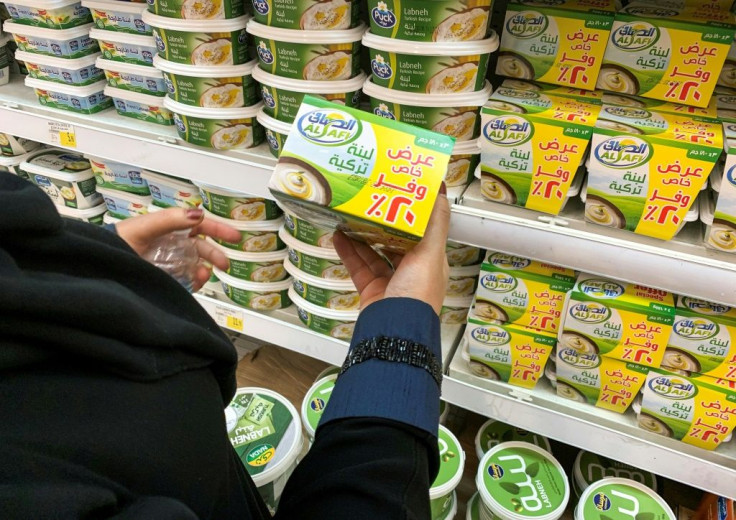 A woman holds a pack of Turkish labneh (strained yogurt) while shopping at a supermarket in Riyadh on October 18