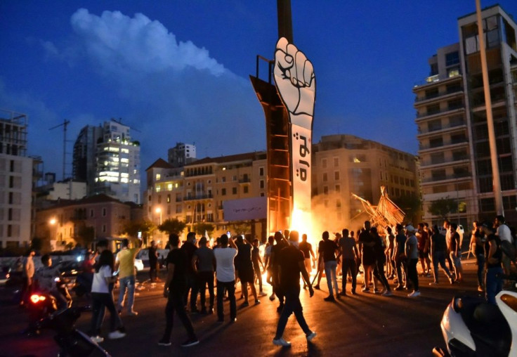 A giant cut-out of a clenched fist, symbol of the anti-government protest movement, was set on fire during anti-Hariri protests on Wednesday but rebuilt the next day