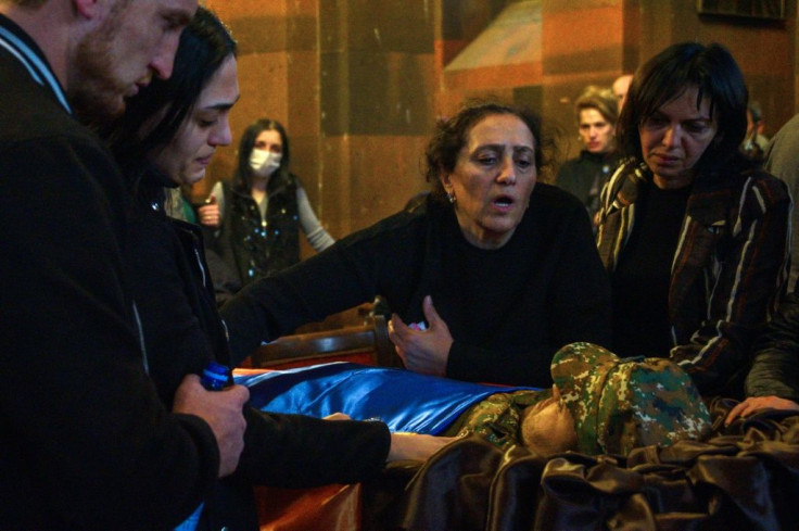 Relatives mourn over the coffin of an Armenian soldier killed in the fighting with Azerbaijan over the breakaway region of Nagorno-Karabakh