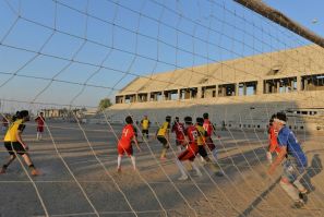 Football players train on the dusty pitch of the Al-Idara al-Mahalia stadium in Mosul which was once used by Islamic State group fighters as a weapons depot and a launchpad for rocket and mortar attacks