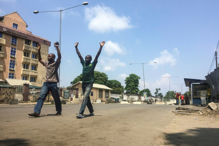 People are obliged to walk with their hands above their heads at security checkpoints in Lagos