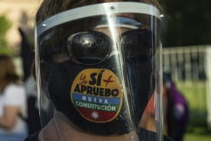 A woman with a face mask reading 'Yes, I do approve the new constitution' takes part in a rally in support of amending the charter established under the military rule of General Augusto Pinochet