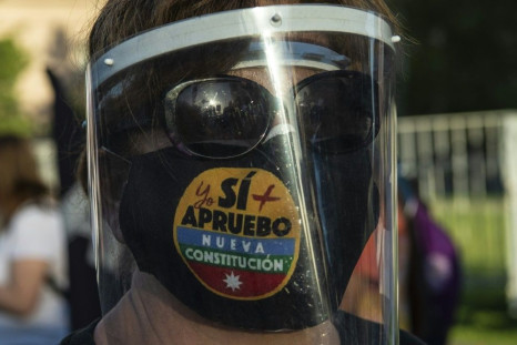 A woman with a face mask reading 'Yes, I do approve the new constitution' takes part in a rally in support of amending the charter established under the military rule of General Augusto Pinochet