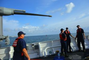 United States Coast Guard personnel stand on the deck of the United States Coast Guard Cutter William Flores on October 17, 2012 just off shore Miami Beach, Florida. The cutter was the third of a planned 58 Fast Response Cutters in the Sentinel Class as t