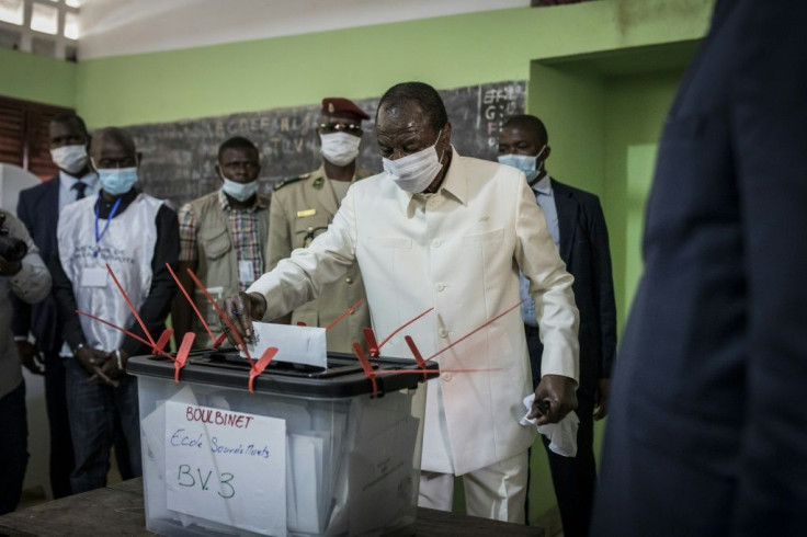 Guinea President Alpha Conde (C) says his third term is legitimate, a claim the opposition disputes