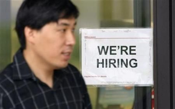 A man walks past a hiring sign in Virginia