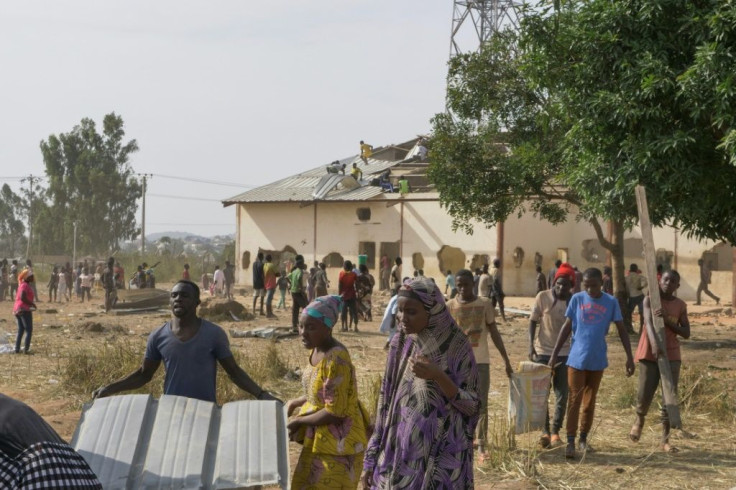 Thousands carried away sacks of cereals and rice and bags of pasta. Looters even stripped away the roof of the building.