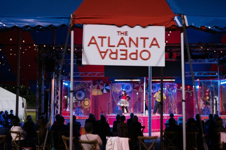 People perform in plastic boxes on stage during The Atlanta Opera's production of "Pagliacci" on October 22, 2020