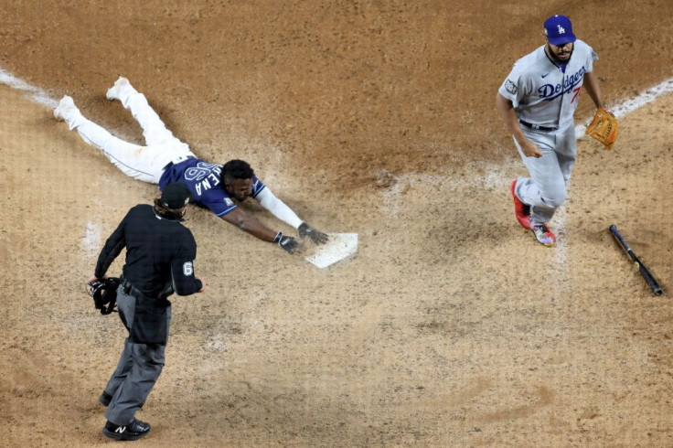 Randy Arozarena slides into home with the winning run in the Tampa Bay Rays 8-7 victory over the Los Angeles Dodgers that leveled the World Series at two games apiece