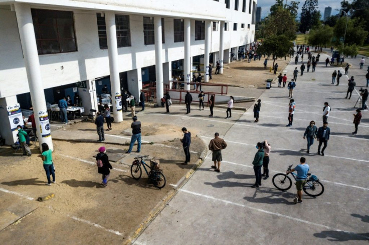 At the National Stadium in Santiago, people queue to cast their ballot in an era-defining referendum on the constitution