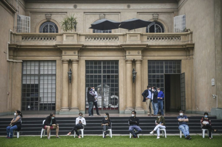 Chileans in neighboring Peru lined up to cast ballots on the constitutional referendum at their country's embassy in Lima