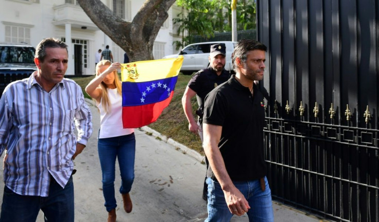 Venezuelan high-profile opposition politician Leopoldo Lopez, pictured in 2019, followed by his wife Lilian Tintori carrying a Venezuelan flag walks out the Spanish embassy in Caracas