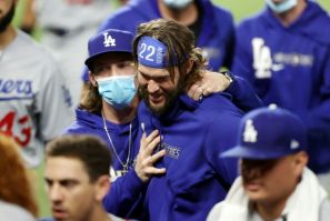 Los Angeles Dodgers pitcher Clayton Kershaw, 22, celebrates with his teammates following their 4-2 victory against the Tampa Bay Rays in game five of the 2020 World Series