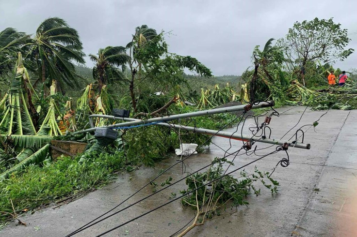 A fallen power line blocks a road after tropical storm Molave hit the town of Pola, Oriental Mindoro province