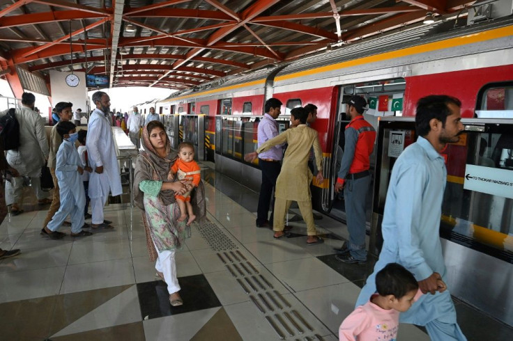 Passengers board one of Larohe's new metro carriages