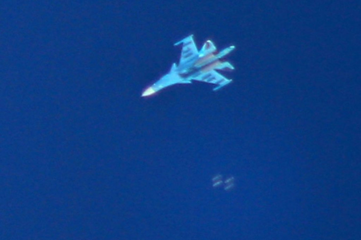 A picture taken on September 7, 2018 shows a Russian Sukhoi Su-34 fighter jet dropping bombs over the Syrian village of Kafr Ain in the northwestern province of Idlib