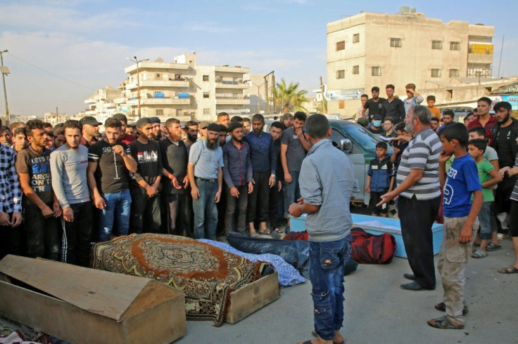 Syrians take part in the funeral of 10 fighters with the Turkey-backed Faylaq al-Sham rebel faction in Syria, in the northwestern city of Idlib, on October 26, 2020, following their death in a Russian air strike