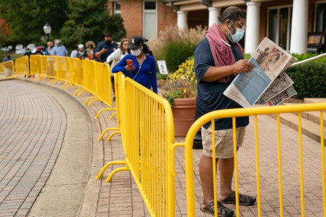 People wait in line to cast their ballots at an early voting location in Smyrna, Georgia