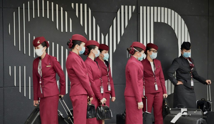 Qatar Airways crew prepare to enter Sydney international airport to fly a repatriation flight back to France on April 2, 2020, amid the coronavirus pandemic