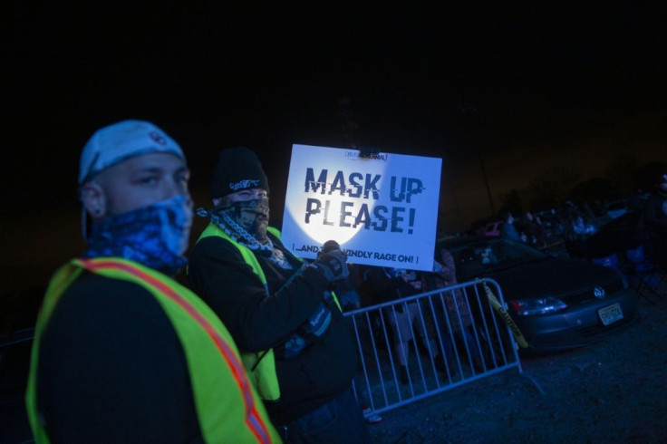 Security guards remind party-goers to keep their masks on