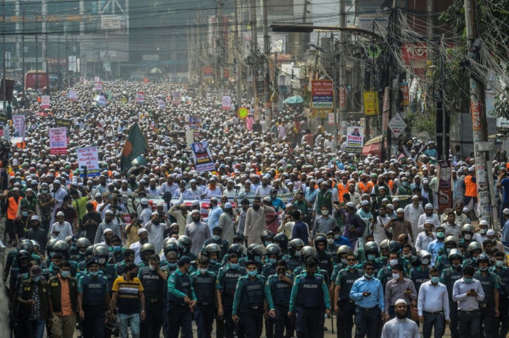 Protesters in Dhaka set alight an effigy of Macron during Tuesday's march