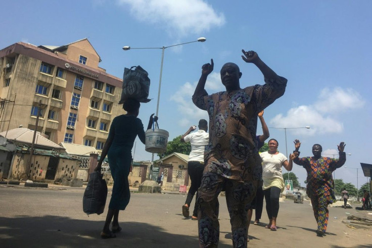 People are told to walk with their hands up as they go through security checkpoints at Lagos' Obalende Market last Friday