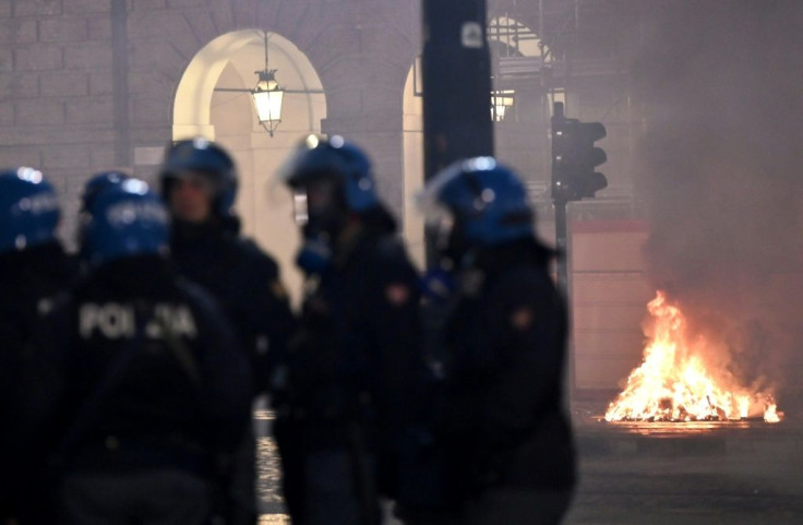 Angry youths threw petrol bombs and stones at police cars and smashed up shop fronts