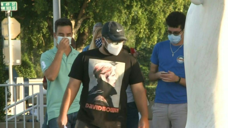 IMAGESEarly voters line up outside a polling station in Miami, Florida, a week before the presidential election.